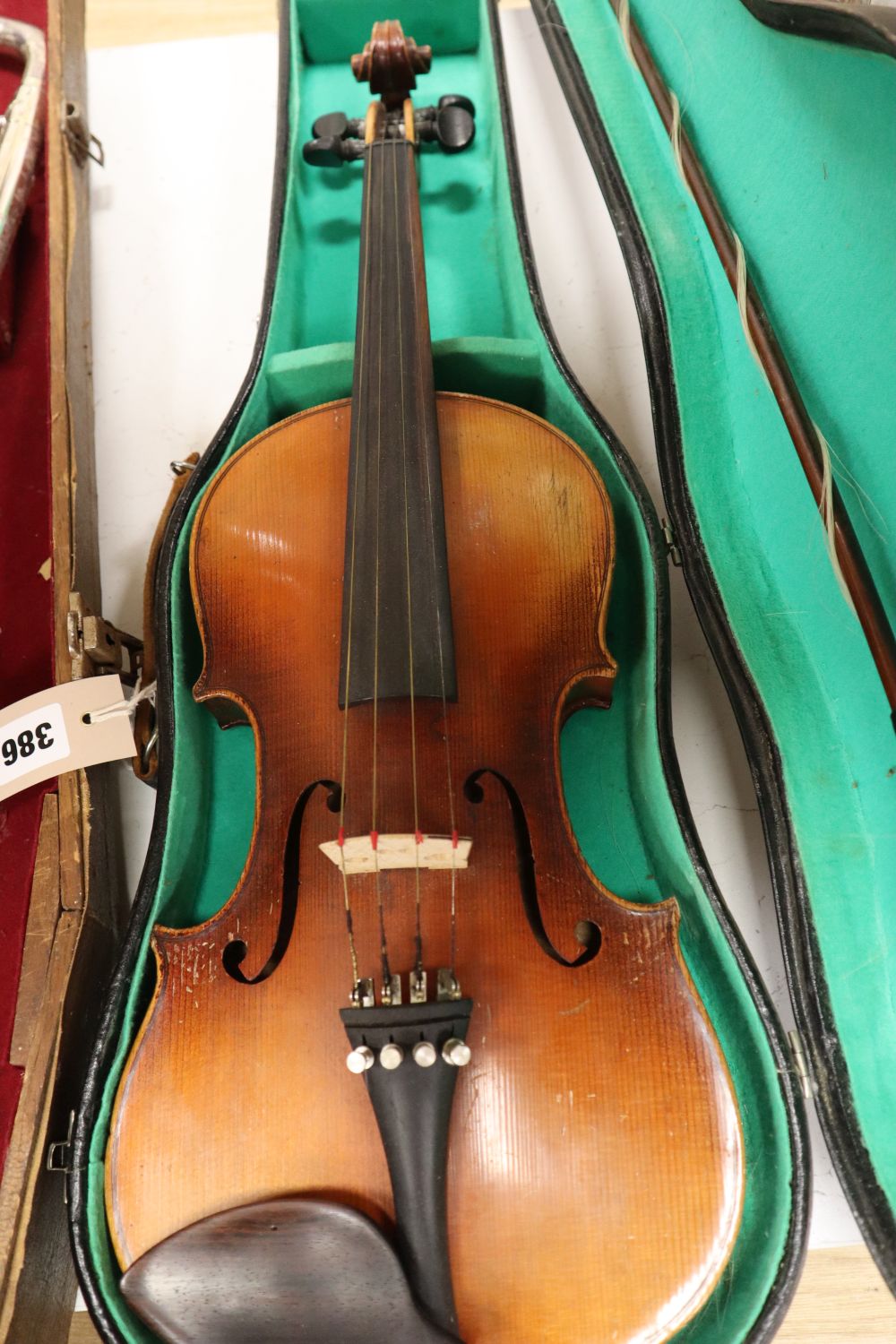 A violin, with 35.5cm back, with bow and some accessories, in case, together with Parrot trombone, cased